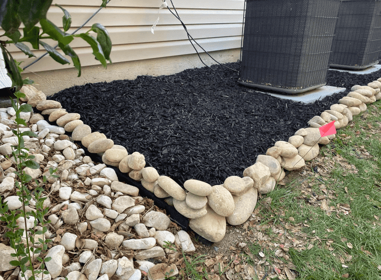 landscaping services outside of a beige house